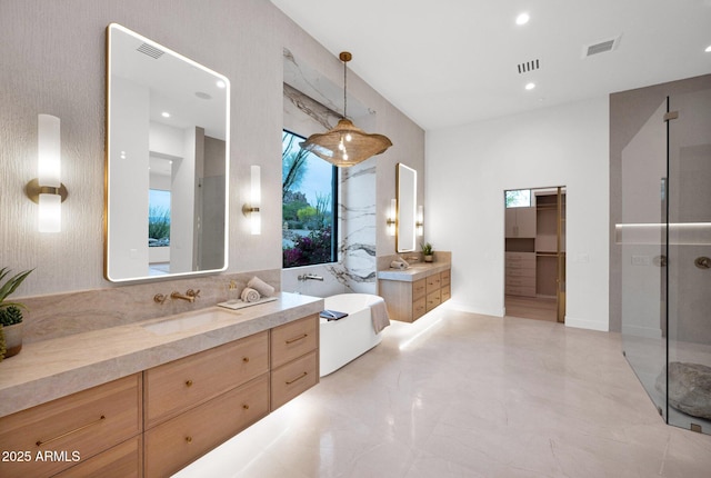 bathroom with a sink, visible vents, and a wealth of natural light