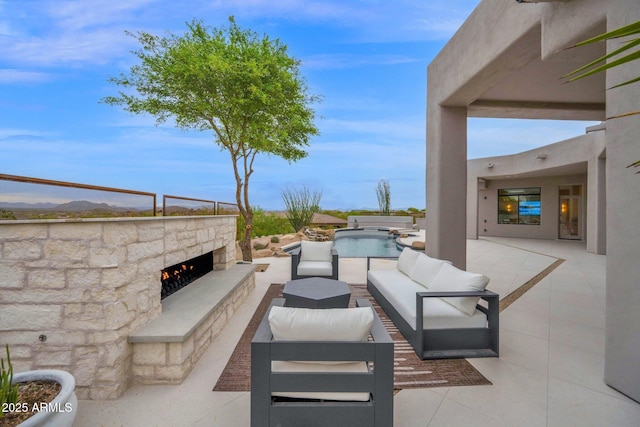 view of patio featuring a mountain view and an outdoor living space with a fireplace