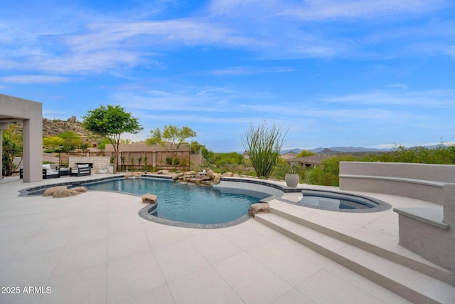 outdoor pool with a patio area, fence, and an in ground hot tub