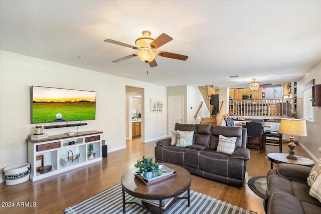 living room with ceiling fan and wood-type flooring