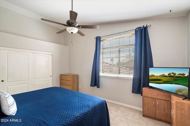 carpeted bedroom featuring a closet and ceiling fan