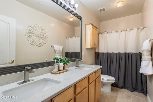 bathroom with vanity, tile patterned floors, and toilet