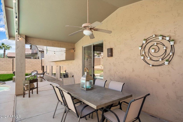 view of patio / terrace with fence, outdoor dining area, and a ceiling fan