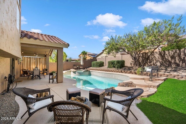 view of swimming pool featuring a patio and ceiling fan