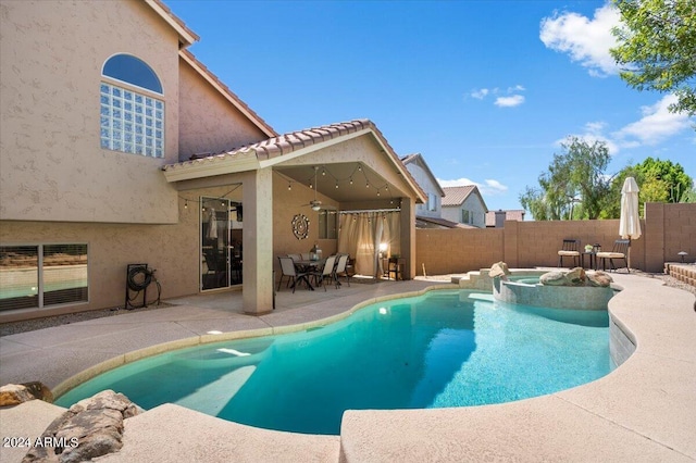 view of swimming pool with an in ground hot tub and a patio