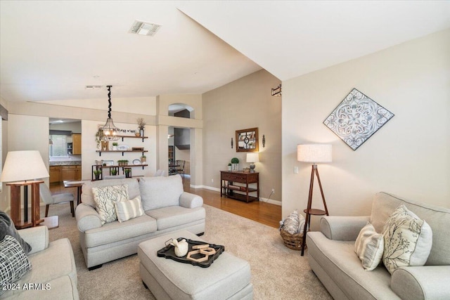 living room featuring vaulted ceiling and light wood-type flooring