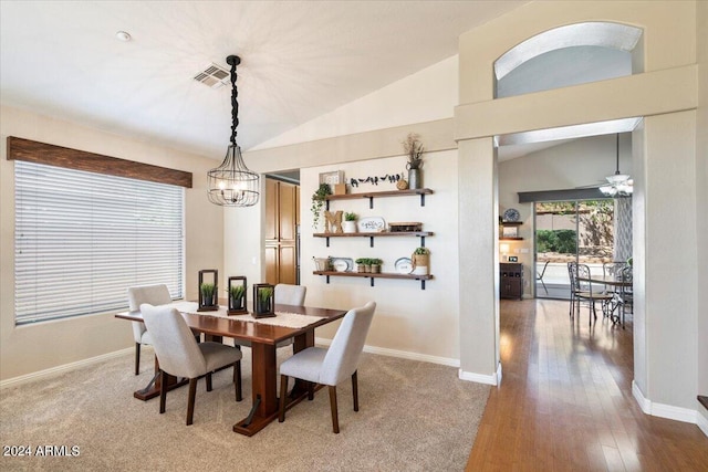 dining room with an inviting chandelier, baseboards, visible vents, and vaulted ceiling