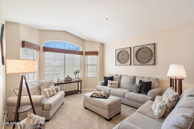 carpeted living room featuring vaulted ceiling