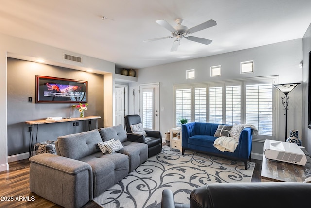 living room with dark hardwood / wood-style flooring and ceiling fan