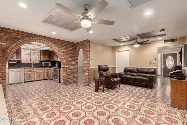 living room featuring ceiling fan and sink