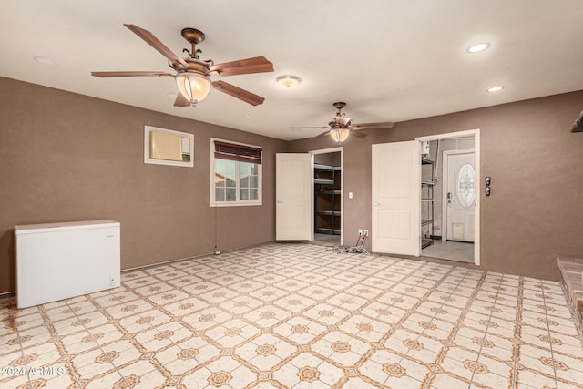 unfurnished living room featuring ceiling fan