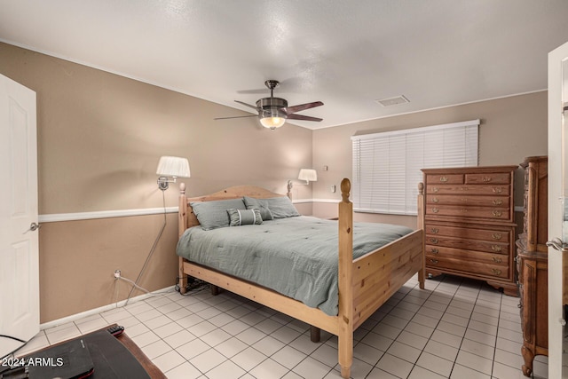 bedroom with ceiling fan and light tile patterned flooring