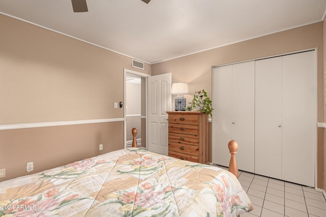 bedroom featuring light tile patterned floors, a closet, and ceiling fan