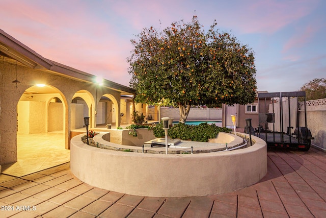 view of patio terrace at dusk