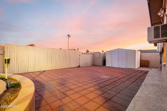 patio terrace at dusk with a storage shed