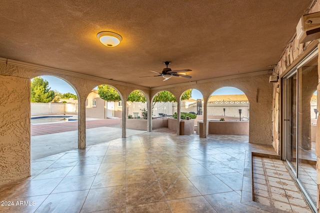 view of patio / terrace with ceiling fan and a fenced in pool