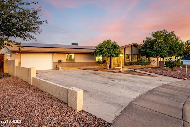 view of front of house with solar panels and a garage