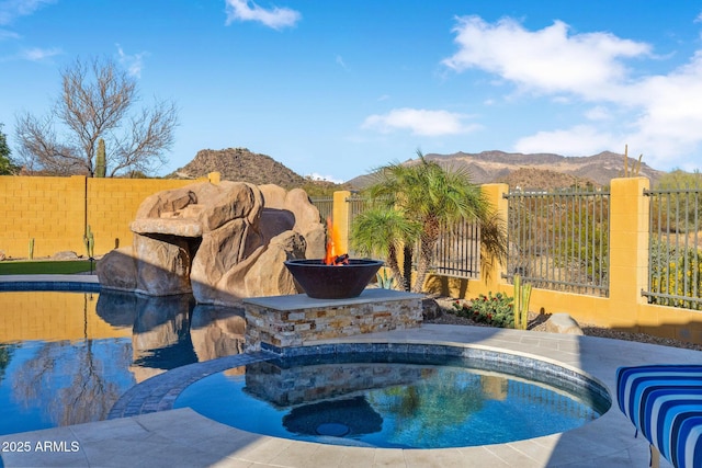 view of swimming pool featuring a fenced backyard and a mountain view