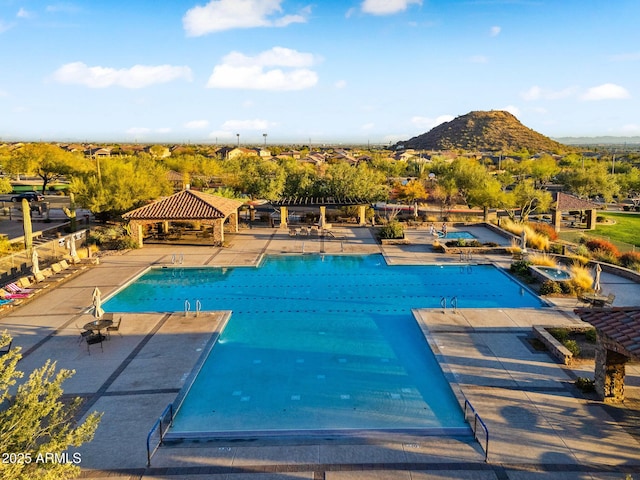 pool featuring a gazebo, a patio area, and a mountain view