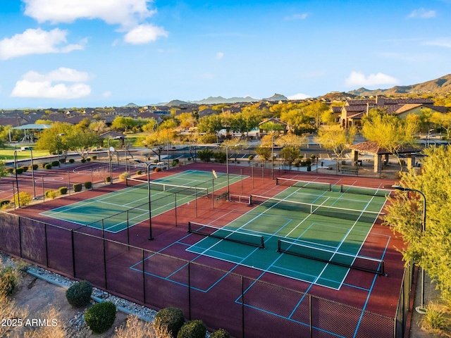 view of sport court featuring a mountain view and fence