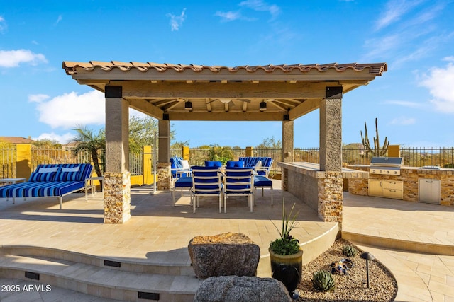 view of patio with a gazebo, exterior kitchen, a fenced backyard, and grilling area