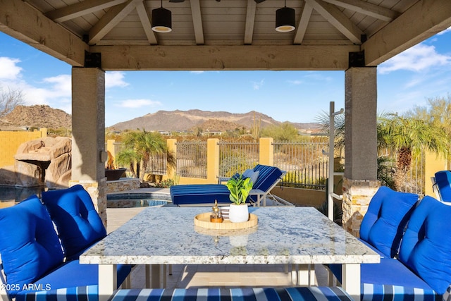 view of patio featuring a gazebo, a fenced in pool, a mountain view, and fence