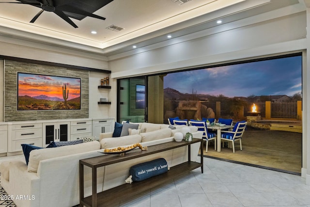 living area with light tile patterned floors, visible vents, recessed lighting, and ceiling fan