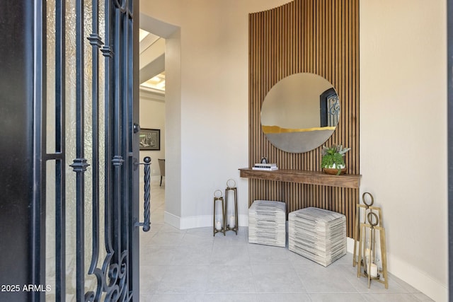 tiled foyer entrance with baseboards