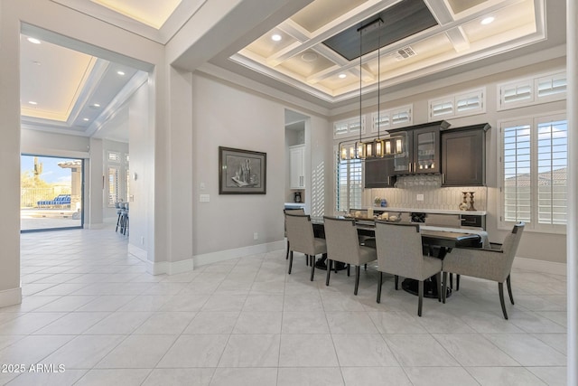 dining room featuring a wealth of natural light, coffered ceiling, baseboards, and a towering ceiling