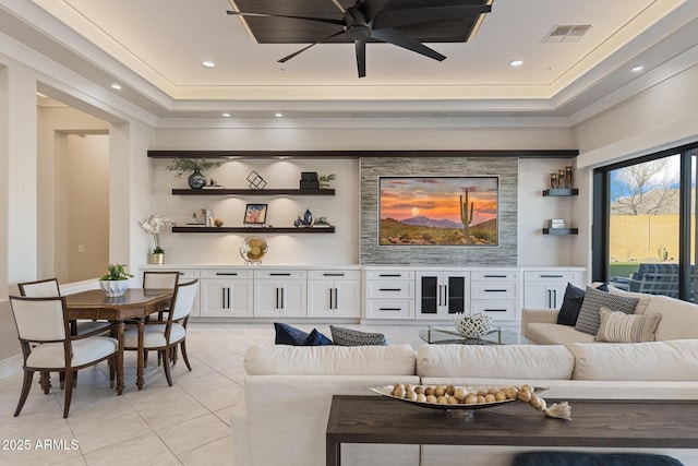 living room featuring visible vents, a tray ceiling, recessed lighting, light tile patterned flooring, and ceiling fan