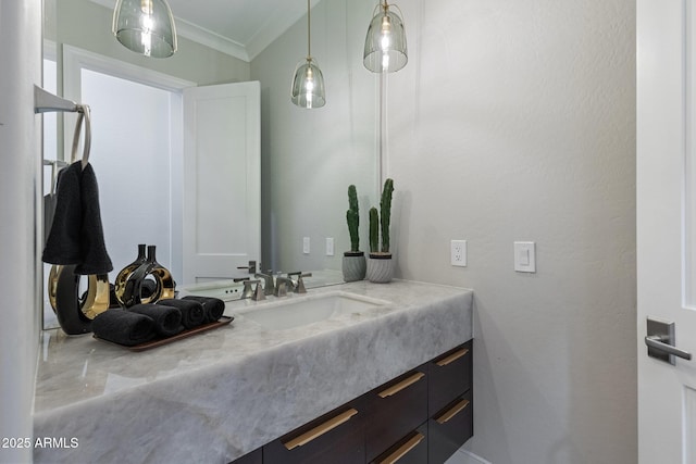 bathroom with vanity and ornamental molding