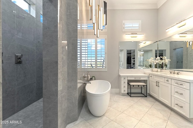 bathroom with vanity, a freestanding tub, ornamental molding, tile patterned flooring, and walk in shower