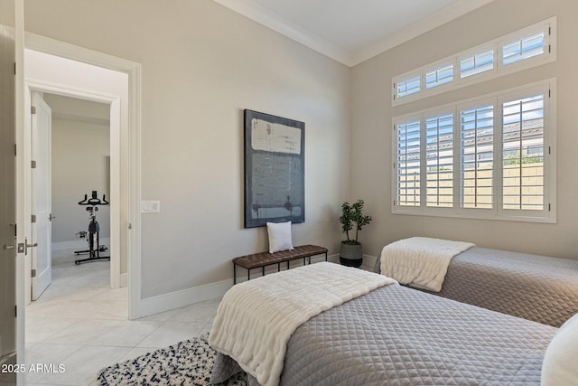 bedroom featuring light tile patterned floors, baseboards, and ornamental molding