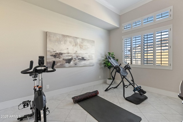 workout area with baseboards, ornamental molding, and tile patterned flooring