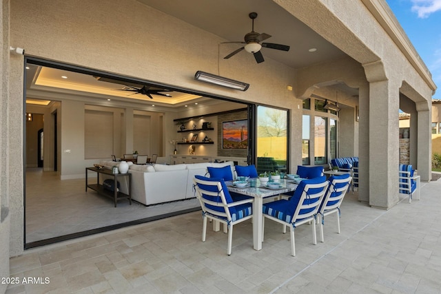 view of patio with outdoor dining area, an outdoor hangout area, and a ceiling fan