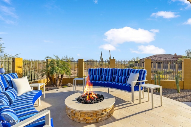 view of patio / terrace featuring an outdoor living space with a fire pit and fence