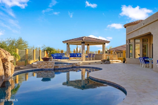 view of swimming pool featuring a patio, fence, a gazebo, a fenced in pool, and an in ground hot tub