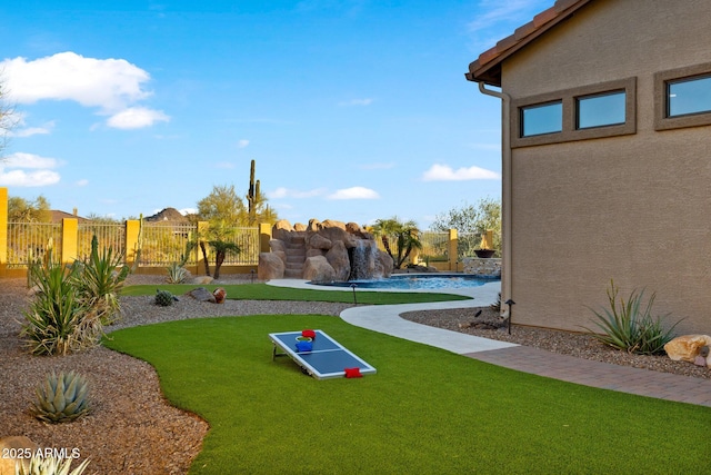 view of yard with fence and a fenced in pool