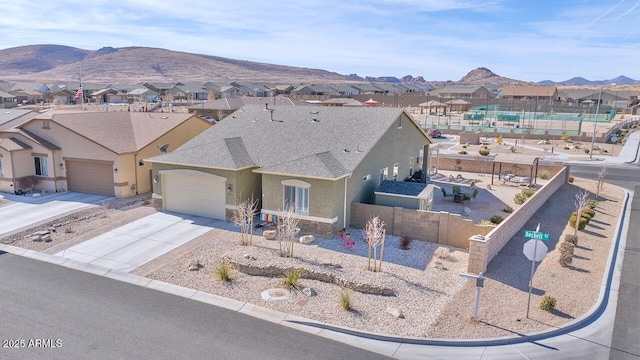 view of front of property featuring a garage and a mountain view