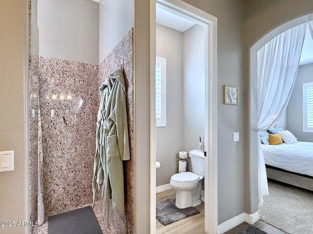 bathroom featuring hardwood / wood-style flooring and toilet