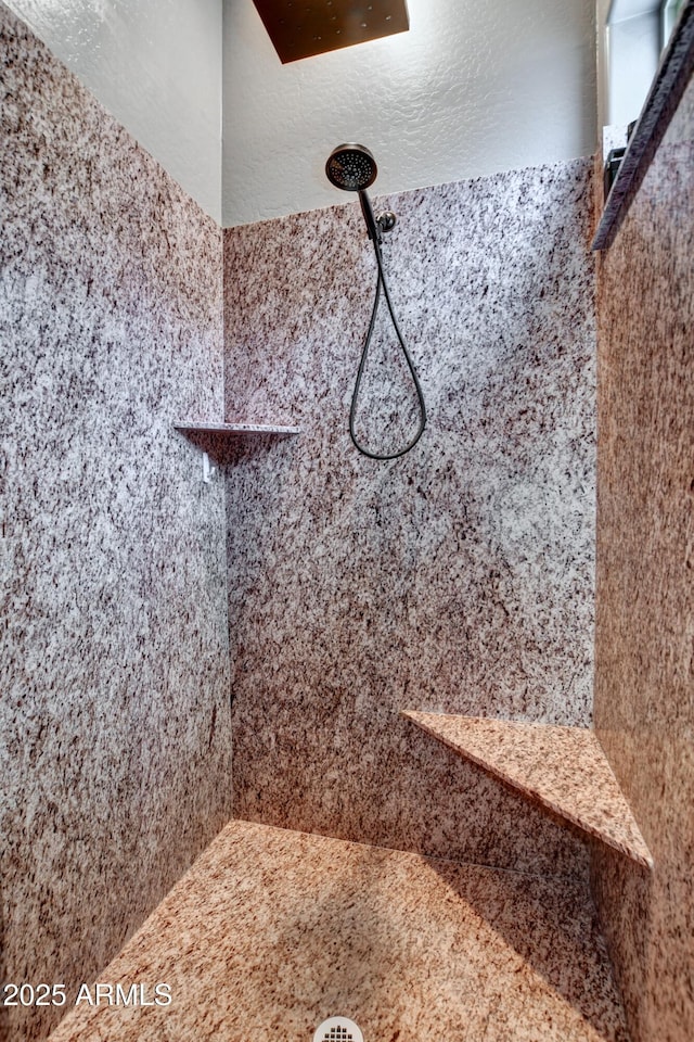 bathroom with a tile shower