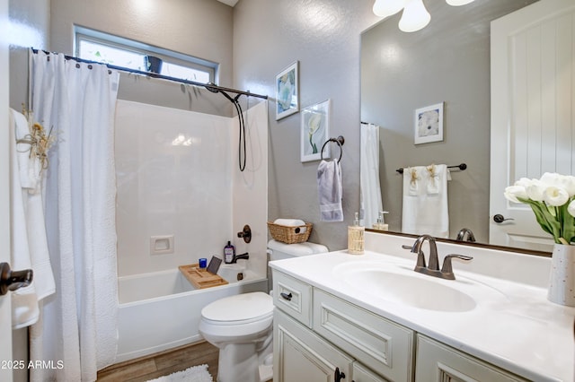 full bathroom with vanity, hardwood / wood-style flooring, toilet, and shower / bath combo