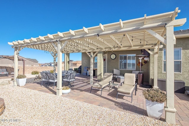 view of patio with area for grilling and a pergola