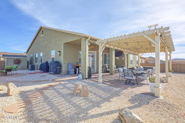 back of property featuring cooling unit, a pergola, and a patio area