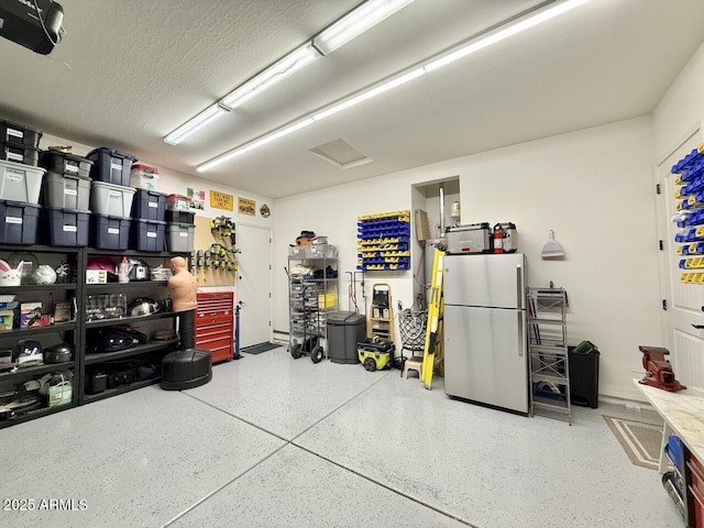 garage with stainless steel refrigerator and a garage door opener