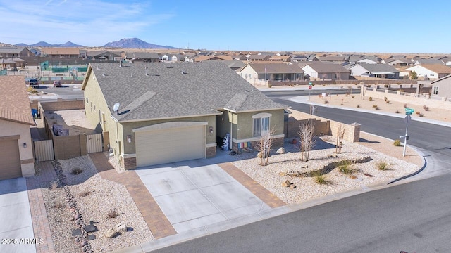 ranch-style house with a garage and a mountain view