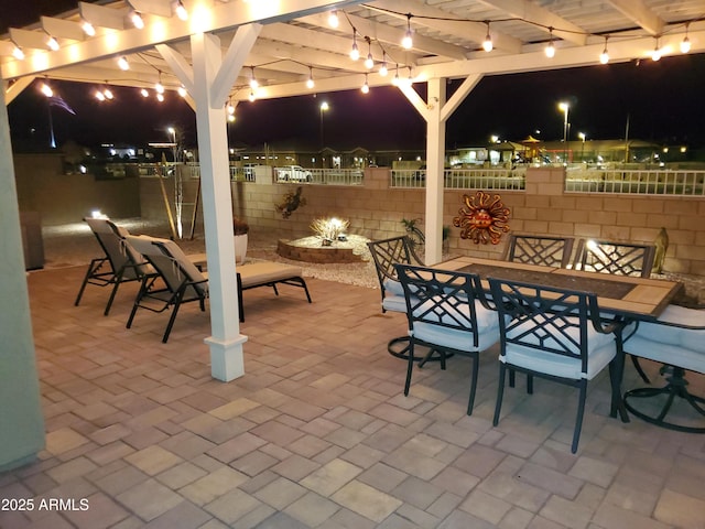 patio at twilight featuring a pergola