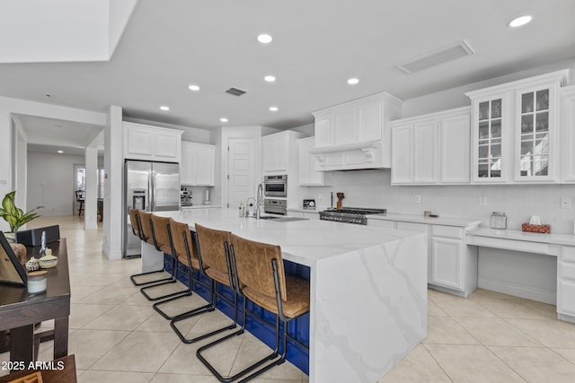 kitchen with light tile patterned floors, visible vents, appliances with stainless steel finishes, and white cabinetry