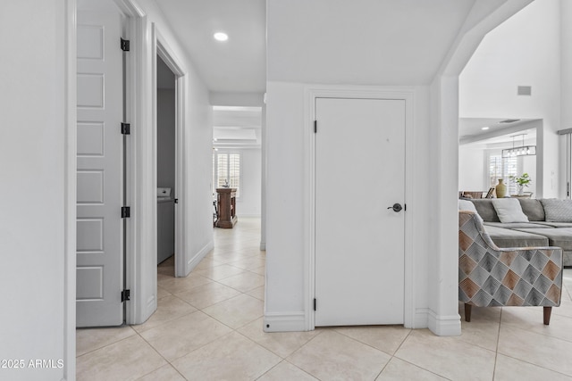 corridor featuring light tile patterned flooring, recessed lighting, and plenty of natural light