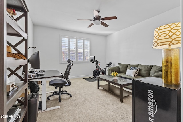 office space featuring carpet flooring, baseboards, and a ceiling fan